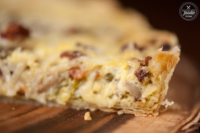 A close up of Quiche Lorraine with bacon, leeks and mushrooms