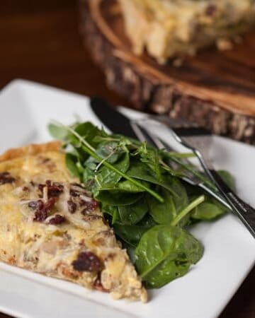 A slice of bacon Quiche Lorraine with spinach