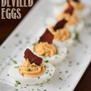 a platter of deviled eggs with bacon