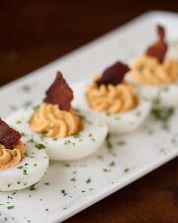 Take standard deviled eggs to the next level by making these flavorful and crowd pleasing Bacon Sriracha Deviled Eggs as your next party appetizer.