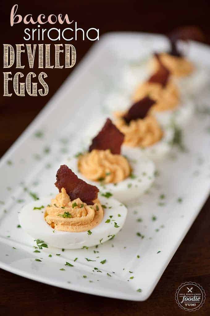 a platter of deviled eggs with bacon