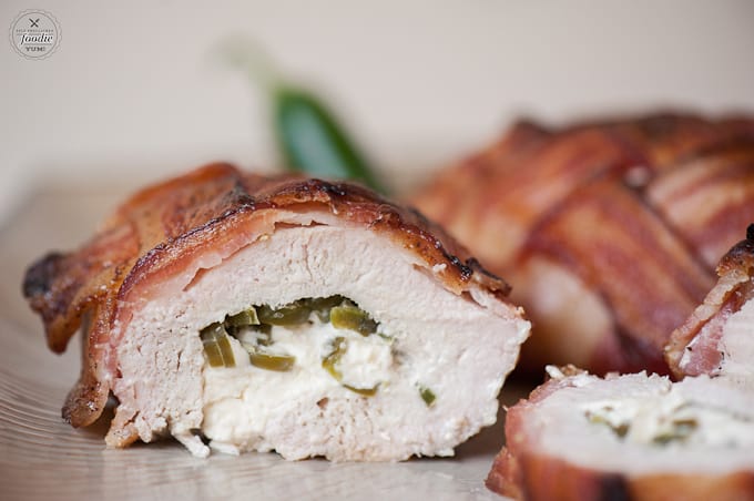 bacon covered chicken with jalapeno popper chicken cut in half