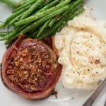 Bacon Wrapped mini Meatloaf is the best comfort food you can make for dinner. Grass fed ground beef, bacon, and more served as individual portion sizes.