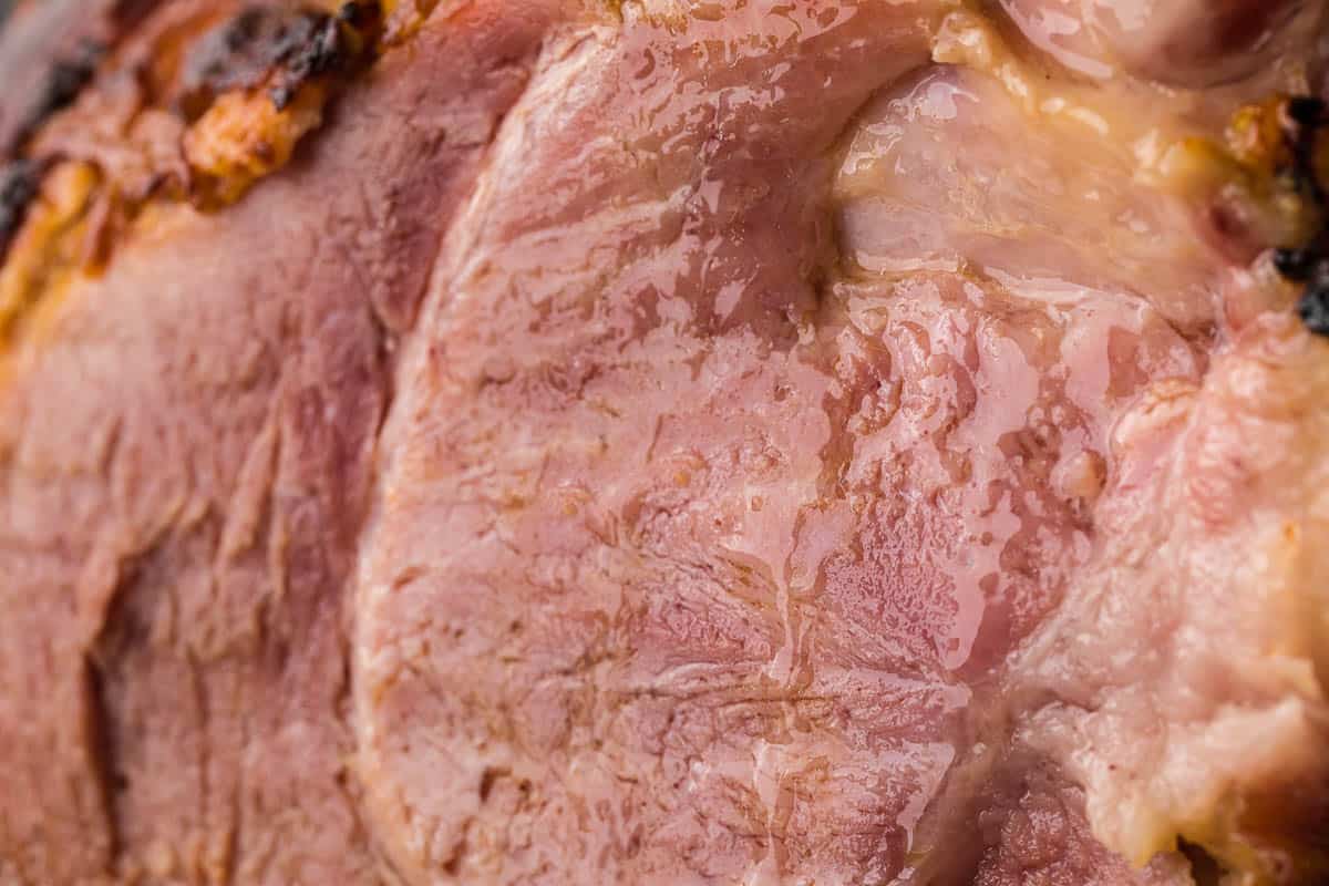 close up of freshly cut ham with juices running down.