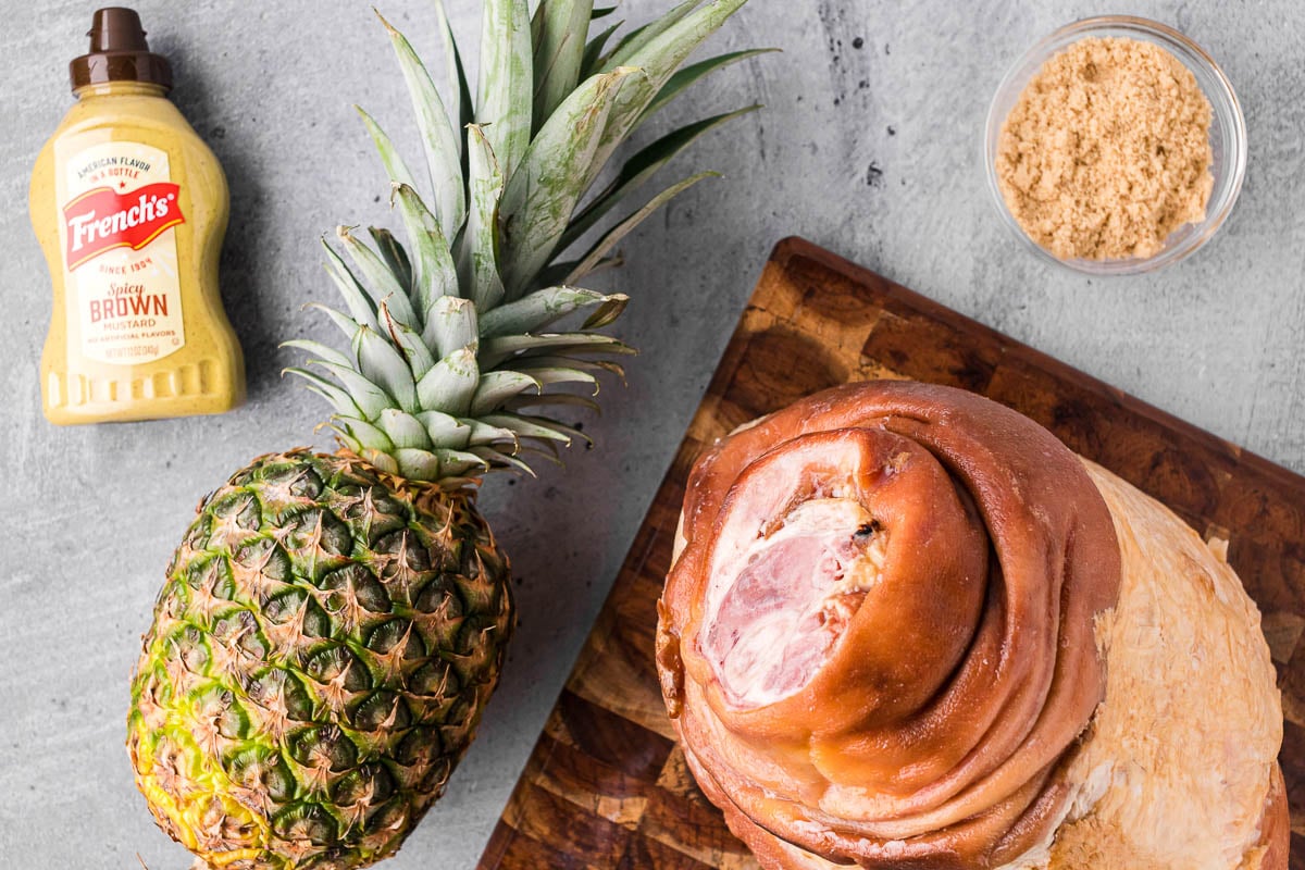 ingredients to bake a whole ham with a 3-ingredient pineapple mustard brown sugar glaze.