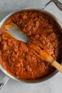 tomato sauce and sausage in pan