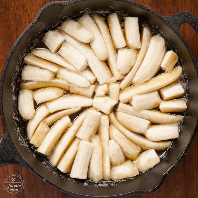 cast iron skillet with banana slices for cake recipe