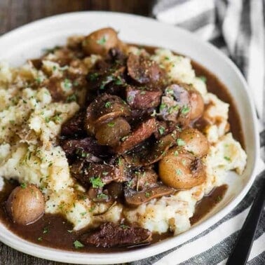 bowl of homemade beef burgundy over mashed potatoes