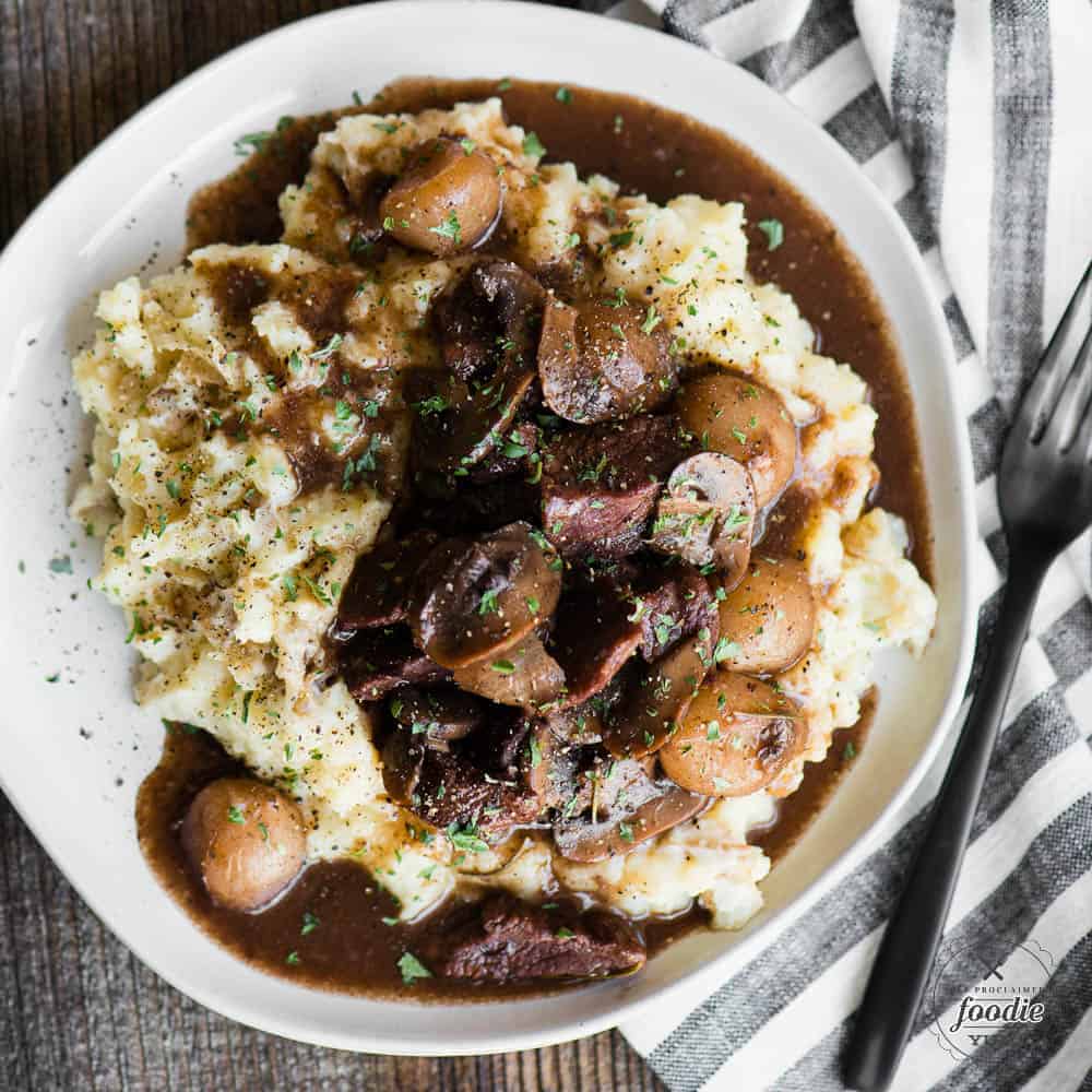 beef burgundy with mushrooms and pearl onions over mashed potatoes