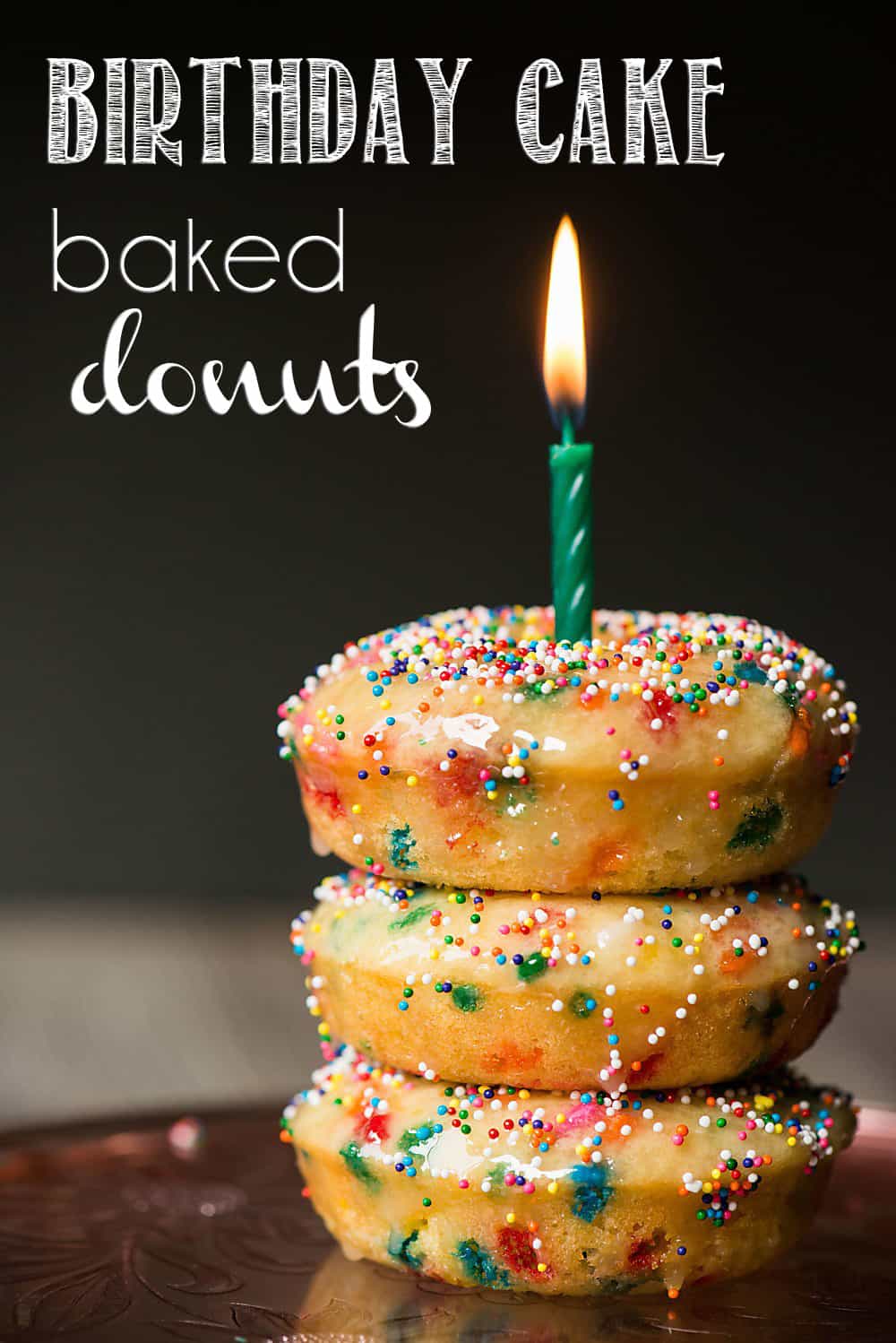 Buttermilk baked donuts with sprinkles and a candle