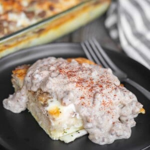 baked breakfast casserole with egg, sausage, cheese, and biscuits smothered in sausage gravy.