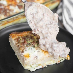 adding sausage gravy to egg and biscuit breakfast casserole.