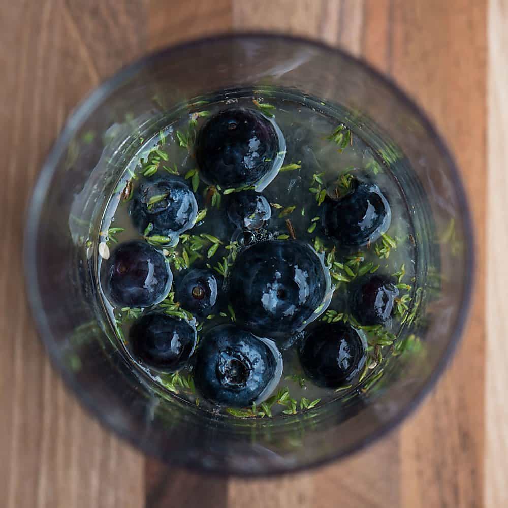 blueberries and thyme in a glass