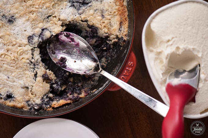 scooping blueberry cobbler made with cake mix out of pan