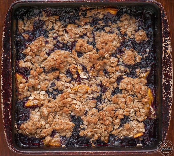 top down photo of peach blueberry crisp with oat topping
