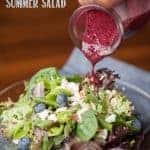 summer salad with blueberry vinaigrette being poured