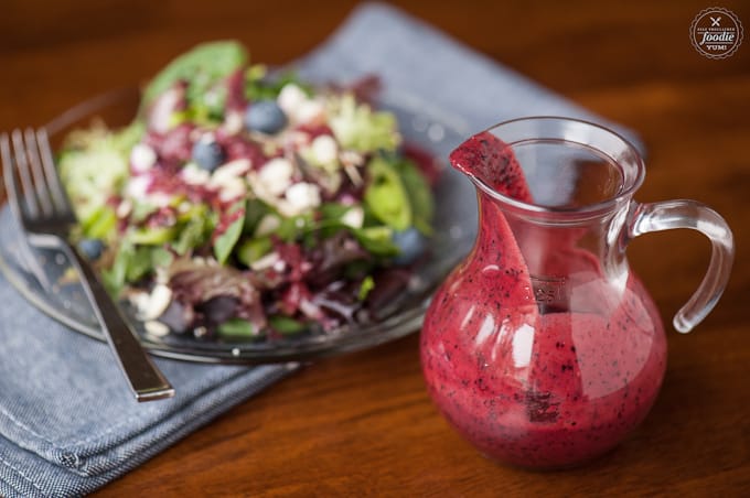 a blueberry vinaigrette next to a salad