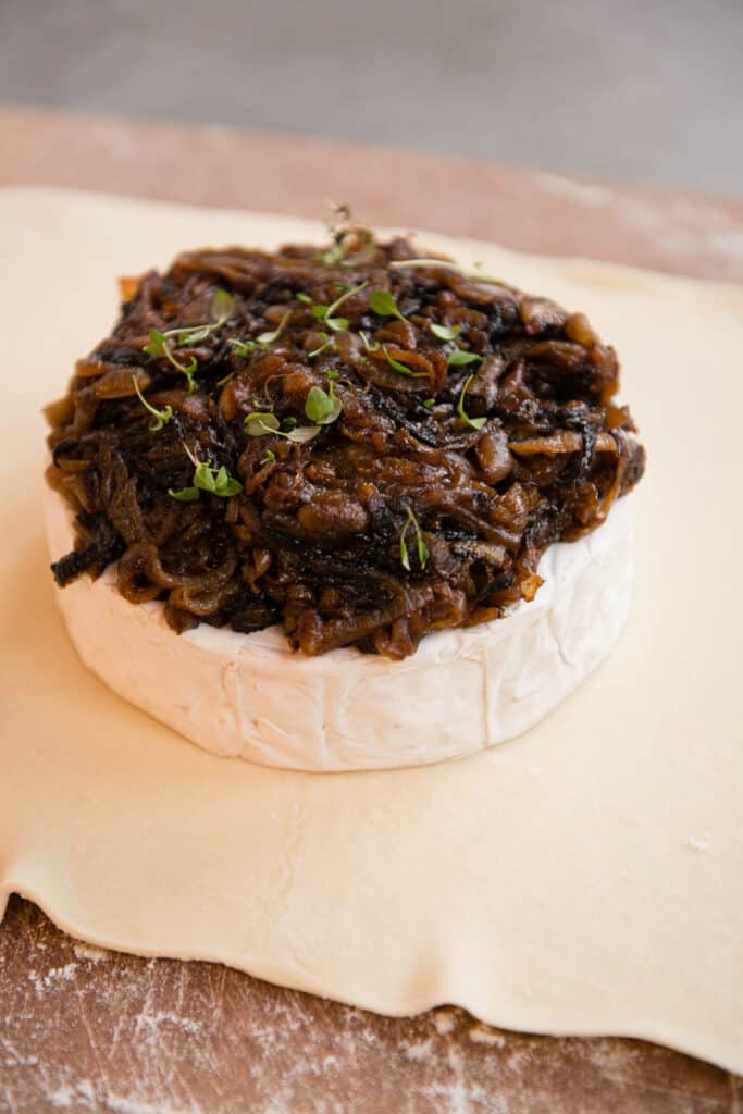 brie wheel topped with caramelized onions