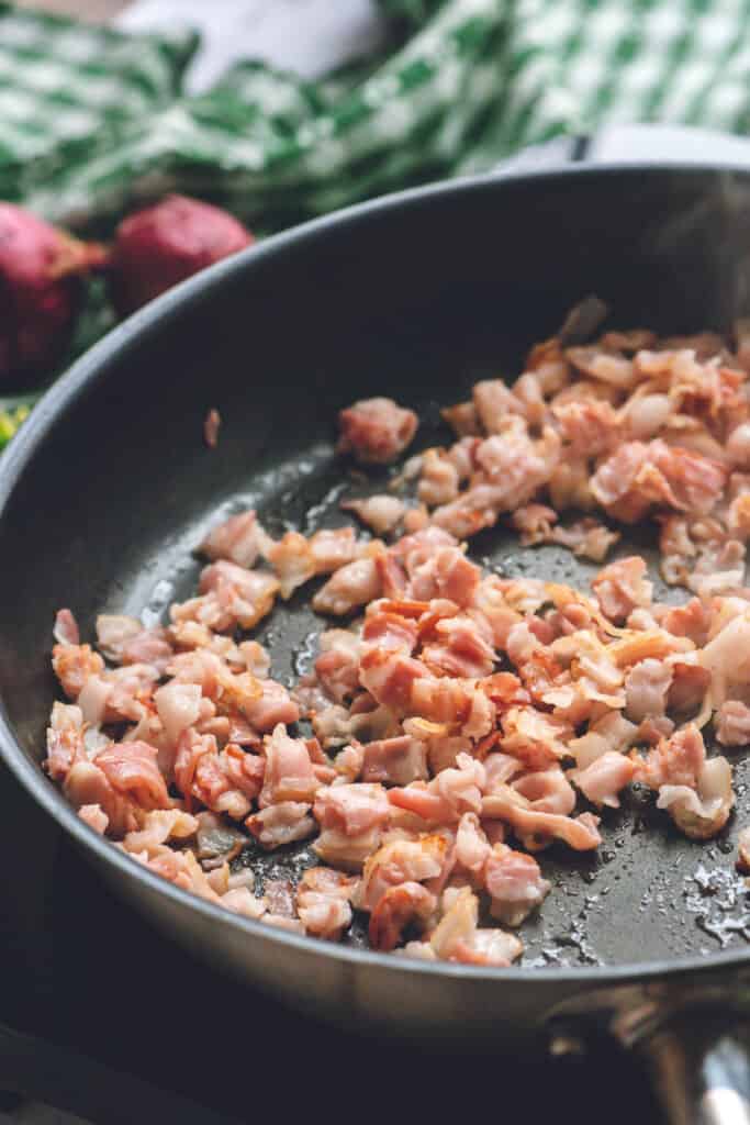 bacon pieces cooking in pan