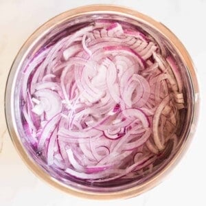 red onions soaking in bowl of water