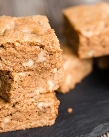 Brown Butter Blondies are a sweet and chewy dessert bar. Think of them as vanilla brownies. This blondie recipe cooks a vanilla bean and walnut pieces in butter until the browned butter becomes nutty and delicious. Brown sugar makes them chewy and perfectly sweet. These brown butter brownies will satisfy any craving!