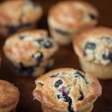 homemade blueberry muffins on brown serving platter
