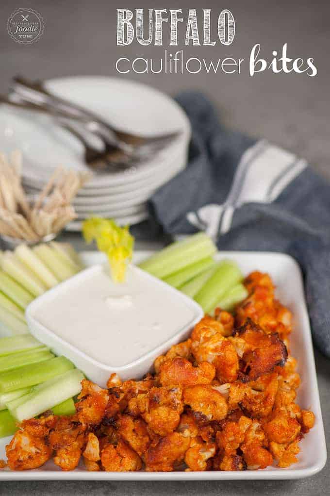 Cauliflower buffalo bites on platter with dressing and celery