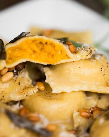 close up of homemade butternut squash ravioli with sage butter sauce