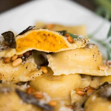 close up of homemade butternut squash ravioli with sage butter sauce
