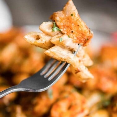 close up of fork with cajun shrimp pasta in cream sauce