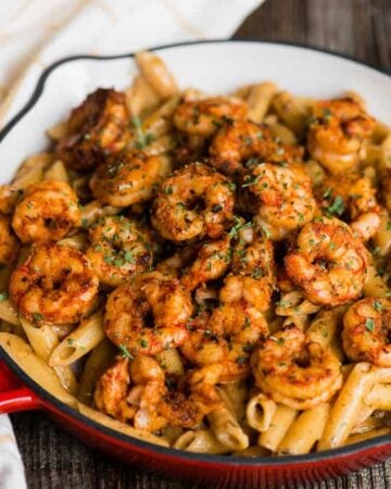 pan filled with cajun shrimp with a creamy sauce and penne pasta