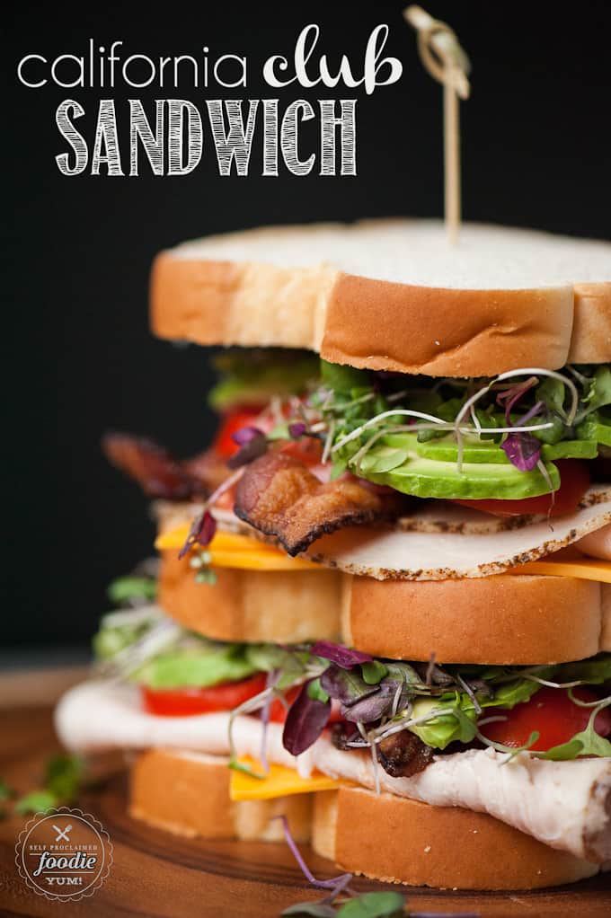 stacked club sandwich with avocado and sprouts