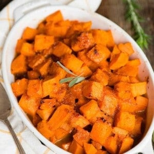 white oval dish with candied sweet potatoes