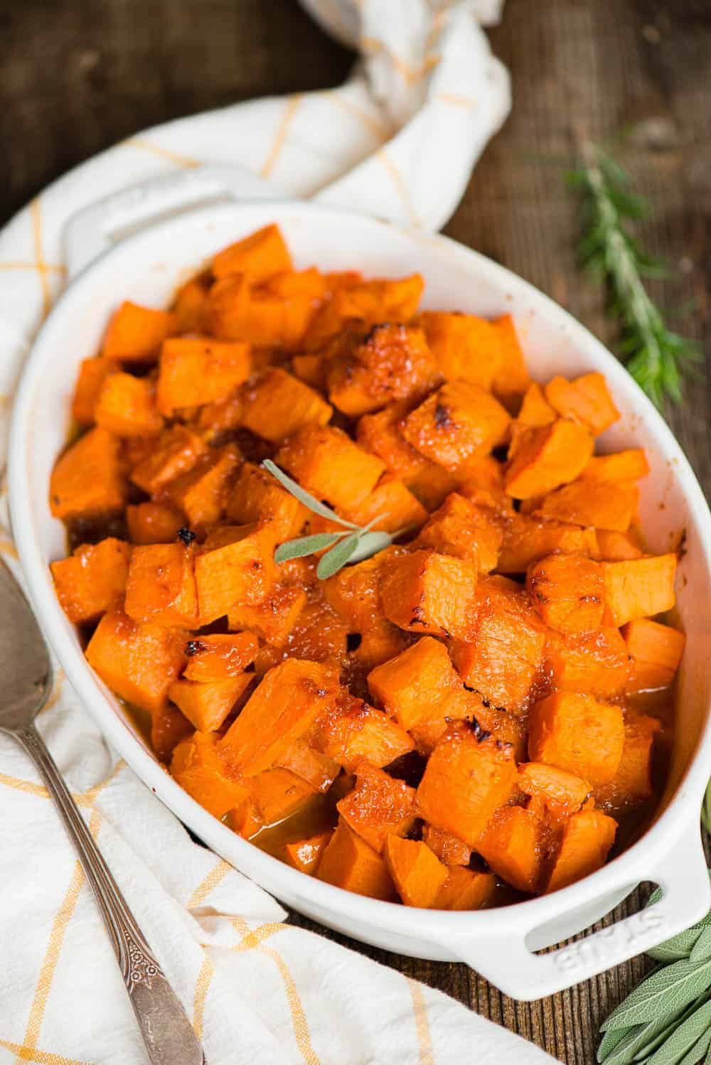 white oval dish with candied sweet potatoes