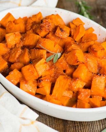white oval platter of homemade candied sweet potatoes