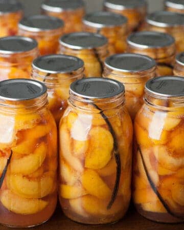 canned peaches in mason jars with vanilla bean