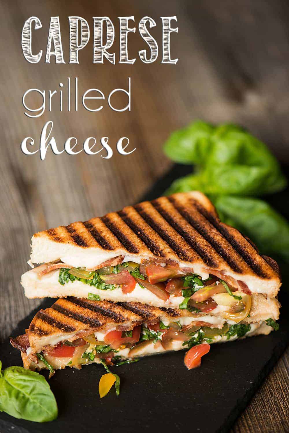 two caprese grilled cheese half sandwiches stacked on top of each other