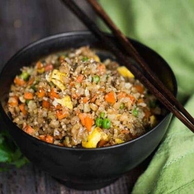 Cauliflower Fried Rice is an easy to make a tasty, low carb meal packed with vitamins and flavor! This "rice" is so good you won't even think you're eating healthy! Minced raw cauliflower is the perfect substitute for rice in this recipe.