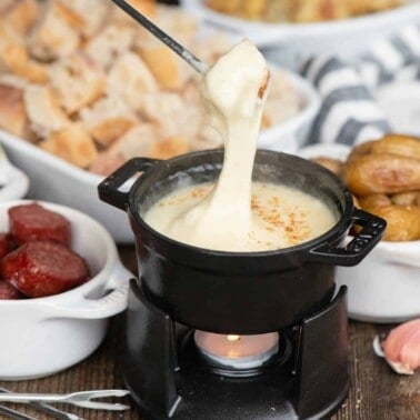 Homemade cheese fondue recipe with assorted dippers.