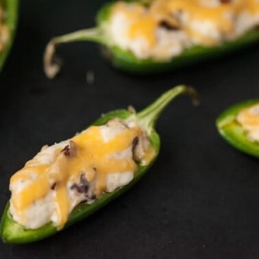 These spicy and zesty Cheesy Bacon Ranch Jalapeno Poppers make the perfect two bite appetizer for any game day celebration.
