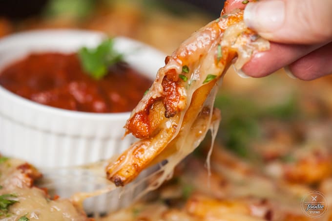 holding cheesy chipotle fries