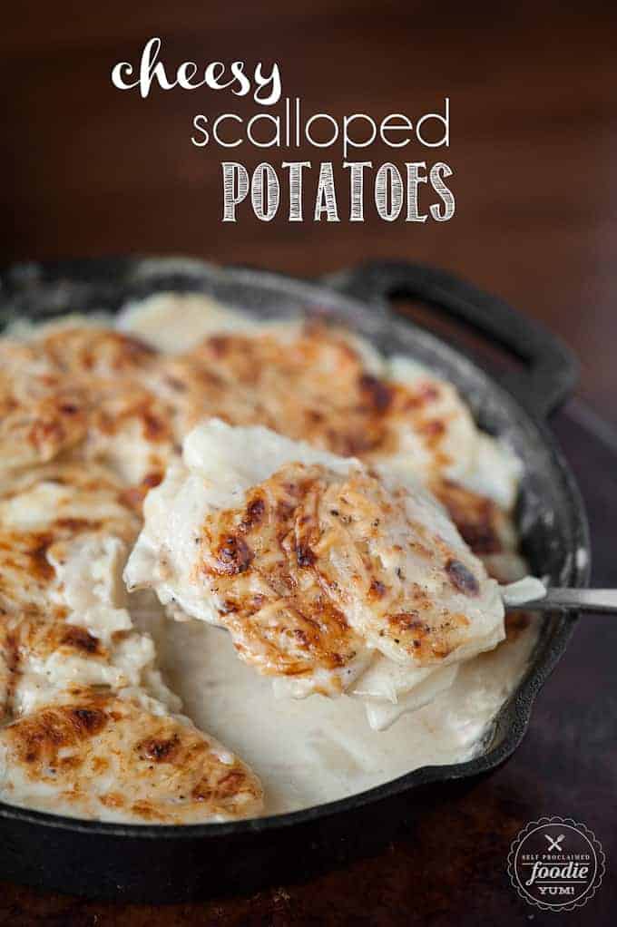 scooping a serving of homemade scalloped potatoes out of cast iron pan