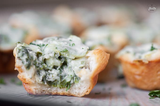 A close up of a spinach artichoke bite