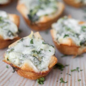 If you're looking for the perfect two bite party appetizer, these Cheesy Spinach Artichoke Bites are definitely a favorite.