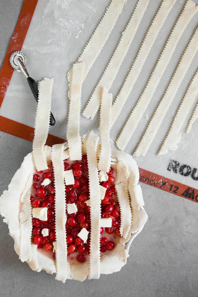 using strips of pie dough to cover cherry pie