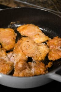 browned boneless skinless chicken thighs in pan