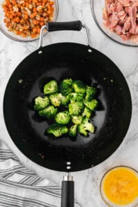 broccoli pieces in wok pan.