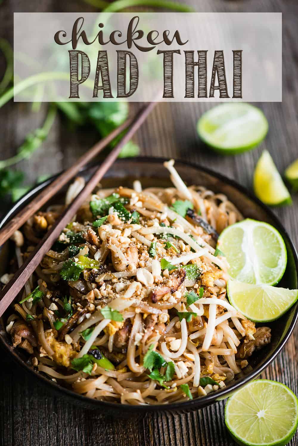 chicken pad thai with limes in the background