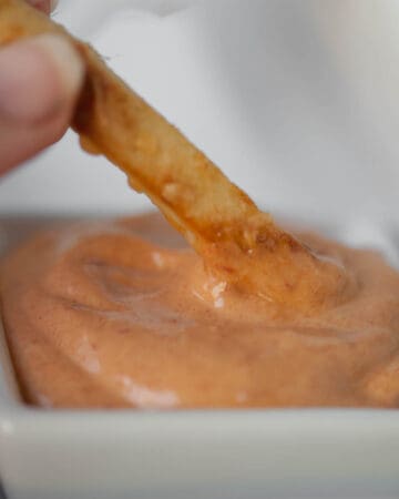 fry dipping in aioli sauce