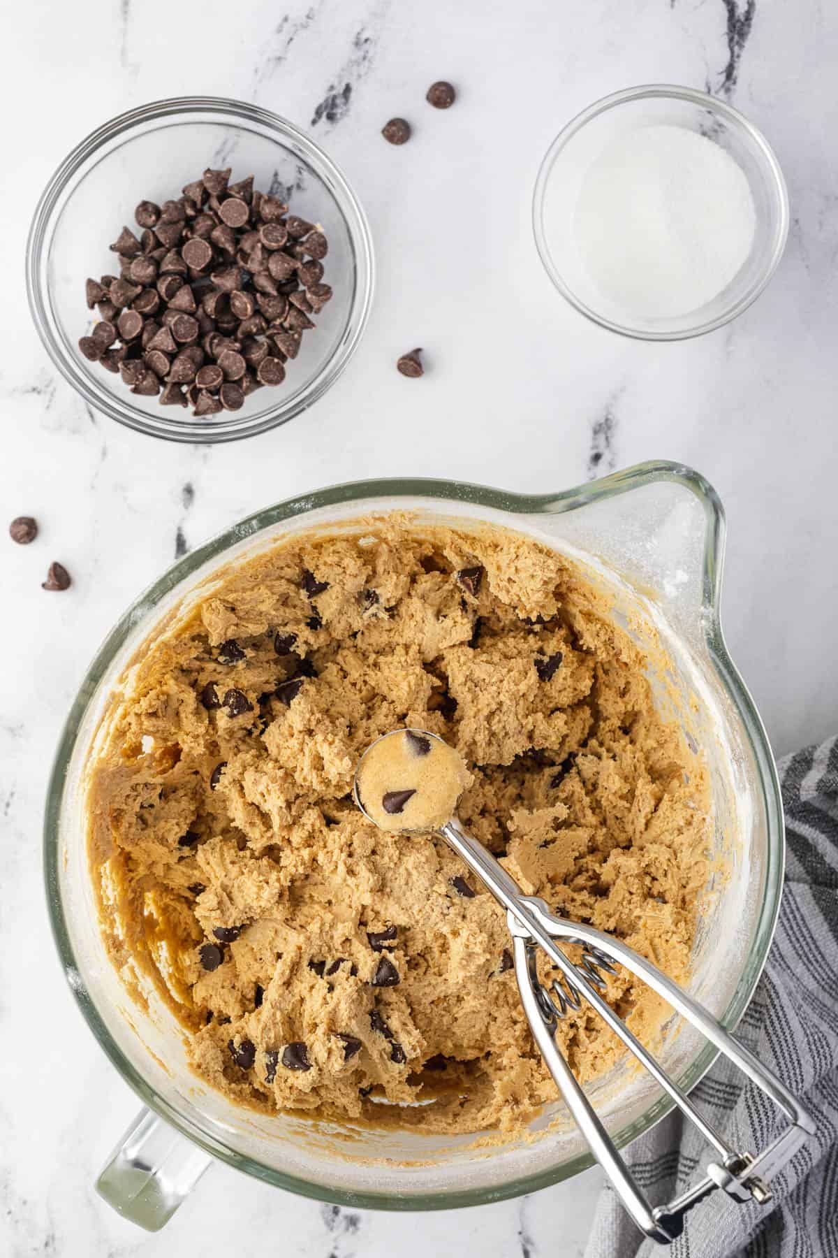 cookie scoop lifting ball of chocolate chip peanut butter cookie dough
